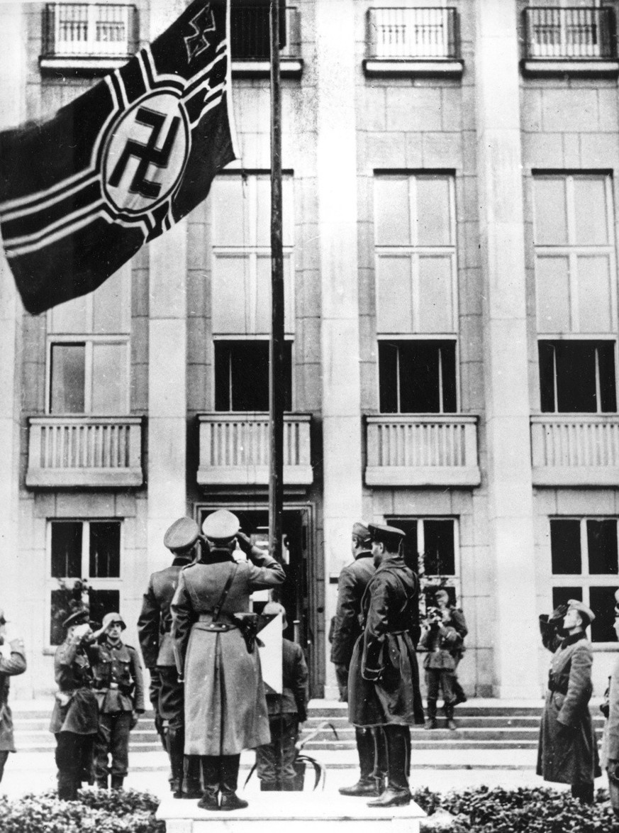 German and Russian officers salute the Nazi swastika flag during a parade in Brest-Litovsk celebrating a border demarcation in Poland in Sept. 1939, following Hitler&#039;s invasion of Poland on Sept. ...
