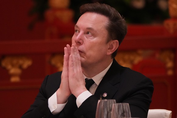 Elon Musk listens to the speech of Chinese President Xi Jinping during a state dinner with President Donald Trump at the Great Hall of the People on Thursday May 14, 2026, in Beijing. (AP Photo/Mark S ...
