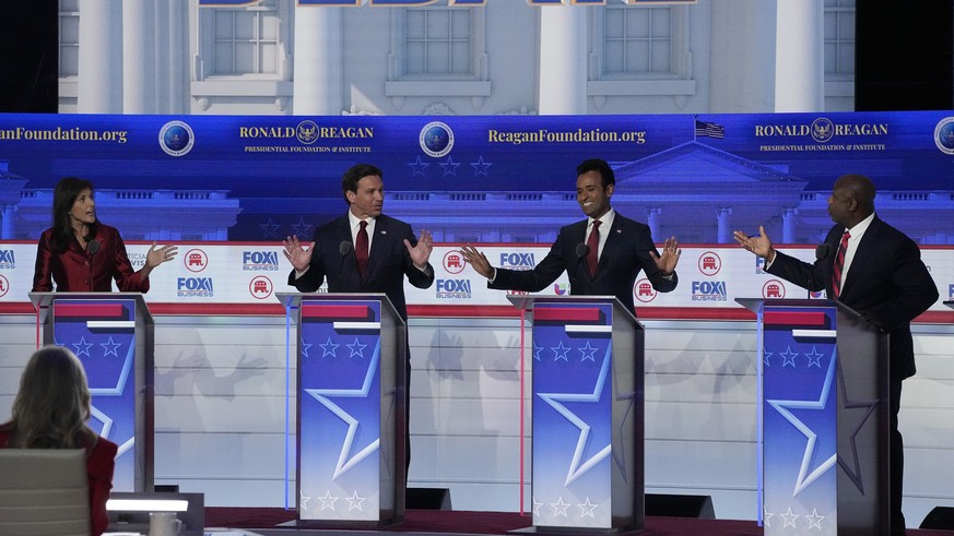 From left to right, former U.N. Ambassador Nikki Haley, Florida Gov. Ron DeSantis, businessman Vivek Ramaswamy and Sen. Tim Scott, R-S.C., argue a point during a Republican presidential primary debate ...