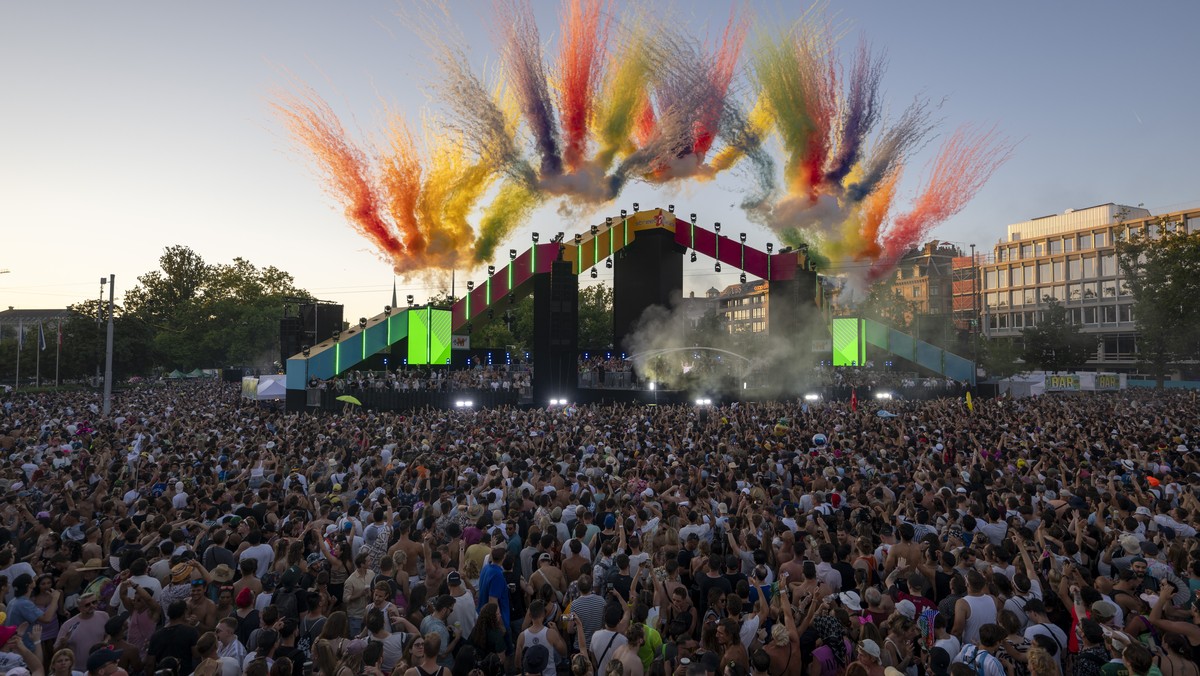 epa11544035 People watch a fireworks display as they attend the 31st Street Parade in Zurich, Switzerland, 10 August 2024. The annual dance music event Street Parade runs this year under the motto   ...
