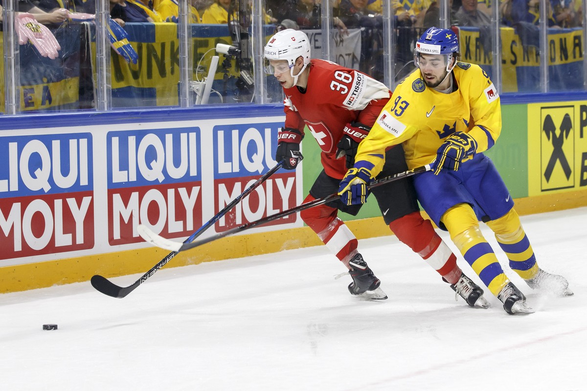 Switzerland's defender Lukas Frick, left, vies for the puck with Sweden's forward Mika Zibanejad, right, during the IIHF 2018 World Championship preliminary round game between Switzerland an ...