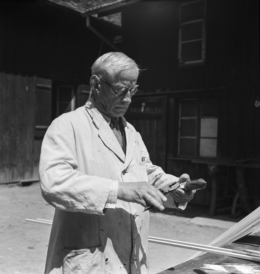 Pyrotechnician Karl Mueller, "inventor of the hailstorm rocket", taken at work in the pyrotechnic factory Mueller in Kreuzlingen, Switzerland, in 1942. Here inventor Karl Mueller attaches th ...