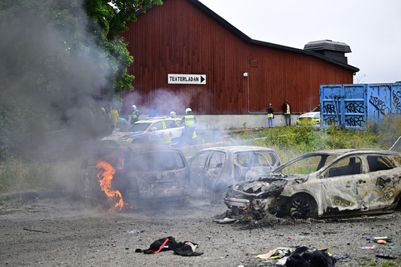 epa10783125 Burnt cars following riots that broke out at the Eritrean cultural festival Eritrea Scandinavia at Jaervafaeltet in northern Stockholm, Sweden, 03 August 2023. The festival, running since  ...