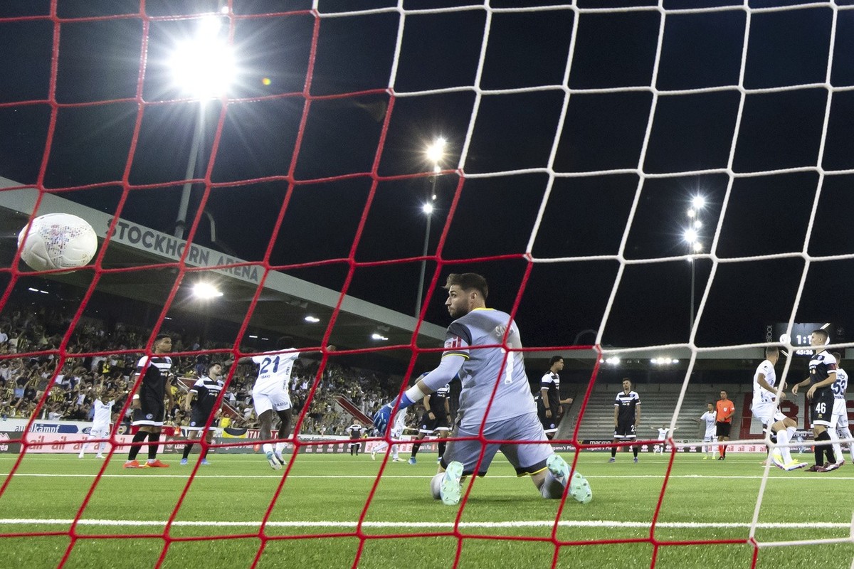 Lugano's goalkeeper Amir Saipi looks at the ball after Fenerbahce's Edin Dzeko scored his side's second goal during a UEFA Champions League qualifying second round first leg soccer matc ...
