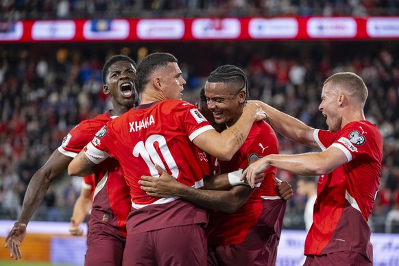 KEYPIX - Switzerland&#039;s Manuel Akanji, center, celebrates after scoring to 1:0 with teammates from left, Breel Embolo and Granit Xhaka, and Silvan Widmer, right, during the FIFA 2026 World Cup Gro ...