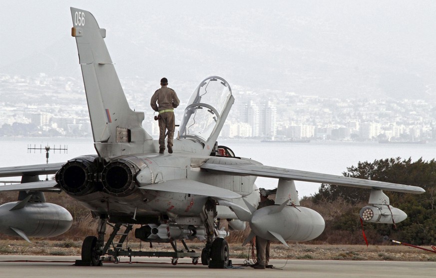 epa04419843 A British tornado fighter jet crew member stands on the jet at RAF Akrotiri in Cyprus, 27 September 2014. The British Ministry of Defence (MOD) has confirmed that Royal Air Force jets have ...