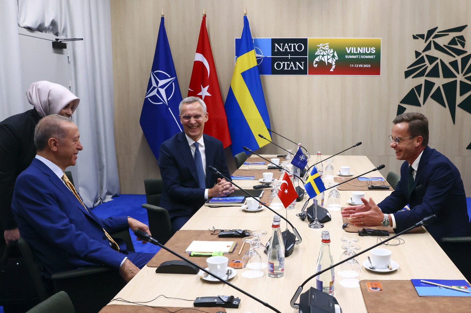 epa10738082 NATO Secretary-General Jens Stoltenberg (C), Turkish President Tayyip Erdogan (L) and Swedish Prime Minister Ulf Kristersson (R) react during a meeting, on the eve of a NATO summit, in Vil ...