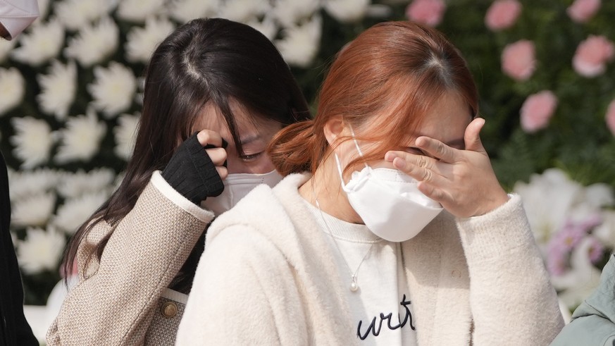 Mourners weep after they pay tribute to the victims of a deadly accident following Saturday night&#039;s Halloween festivities, at a joint memorial altar for victims at Seoul Plaza in Seoul, South Kor ...