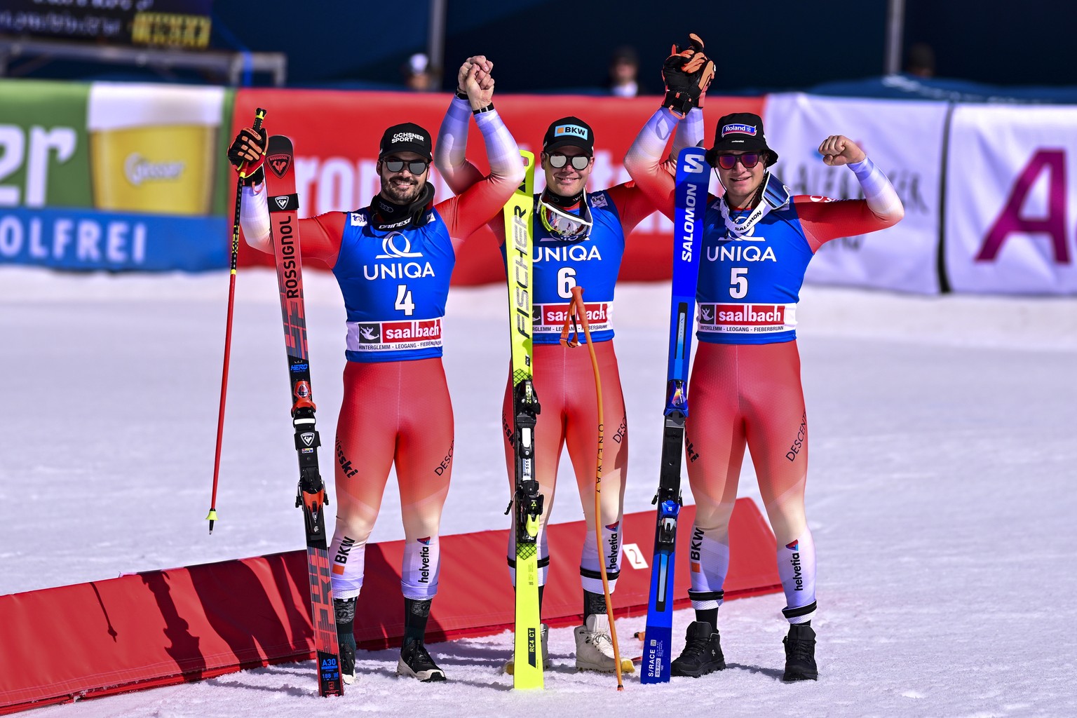 epa11236046 (L-R) Second place Loic Meillard of Switzerland, the winner Stefan Rogentin of Switzerland, and third placed Arnaud Boisset of Switzerland celebrate in the finish area after his run in the ...