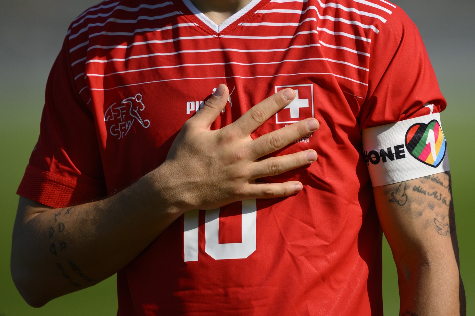 Close up of Switzerland&#039;s midfielder Granit Xhaka with the &quot;One Love&quot; captains arm band as he sings the national anthem during a friendly soccer match between Switzerland and Ghana in p ...