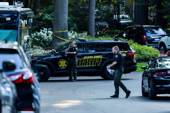 Law enforcement investigate the scene of a fatal house fire on Friday, July 24, 2026, in the in Grand Haven Township, Mich. Ottawa County Sheriff's Office said six children and two adults were fo ...