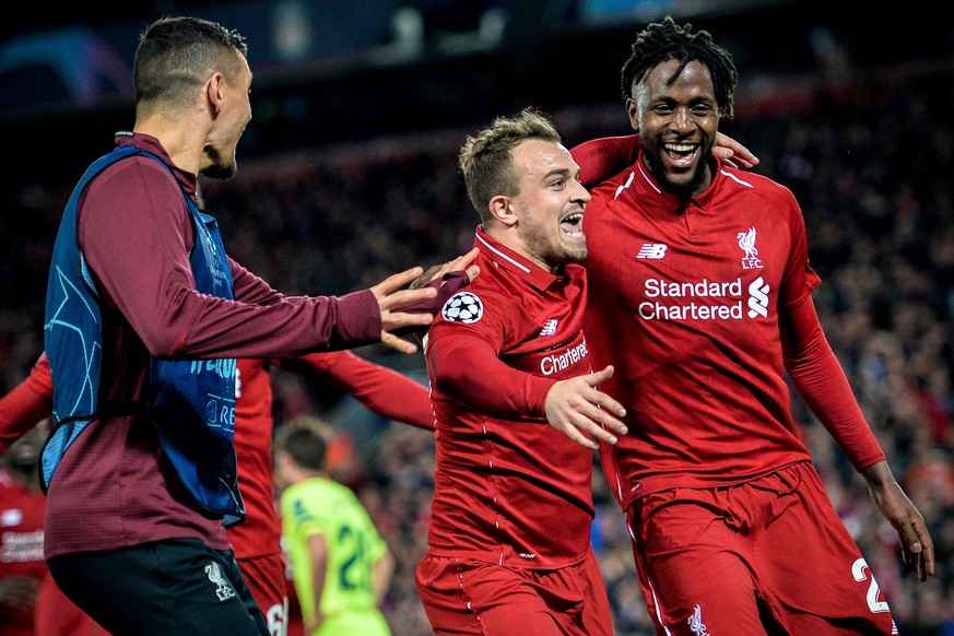 epa07554631 Liverpool&#039;s Divock Origi (R) celebrates with his teammate Xherdan Shaqiri (C) after scoring the 4-0 goal during the UEFA Champions League semi final second leg soccer match between Li ...