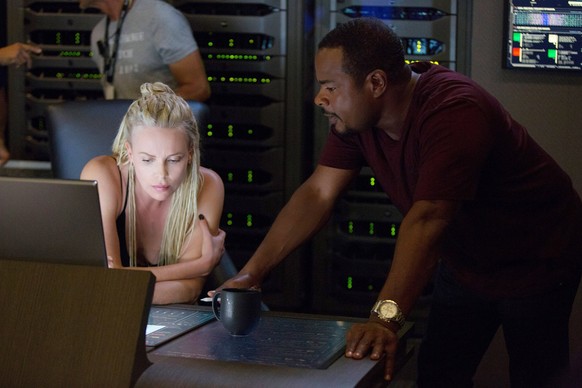 THE FATE OF THE FURIOUS, aka FAST & FURIOUS 8, from left, Charlize Theron, director F. Gary Gray, on set, 2017. ph: Matt Kennedy.  Universal Studios/courtesy of Everett Collection Universal/courtesy of E ...