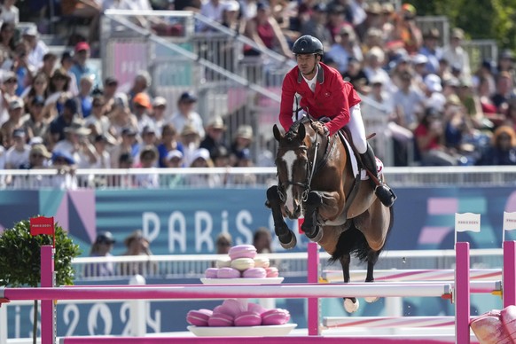 Switzerland&#039;s Steve Guerdat, riding Dynamix of Belheme, during the Equestrian Team Jumping competition, at the 2024 Summer Olympics, Thursday, Aug. 1, 2024, in Versailles, France. (AP Photo/Mosa& ...