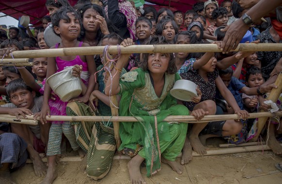 Rohingya Muslim children who crossed over from Myanmar into Bangladesh, wait squashed against each other to receive food handouts distributed to children and women by a Turkish aid agency at Thaingkha ...