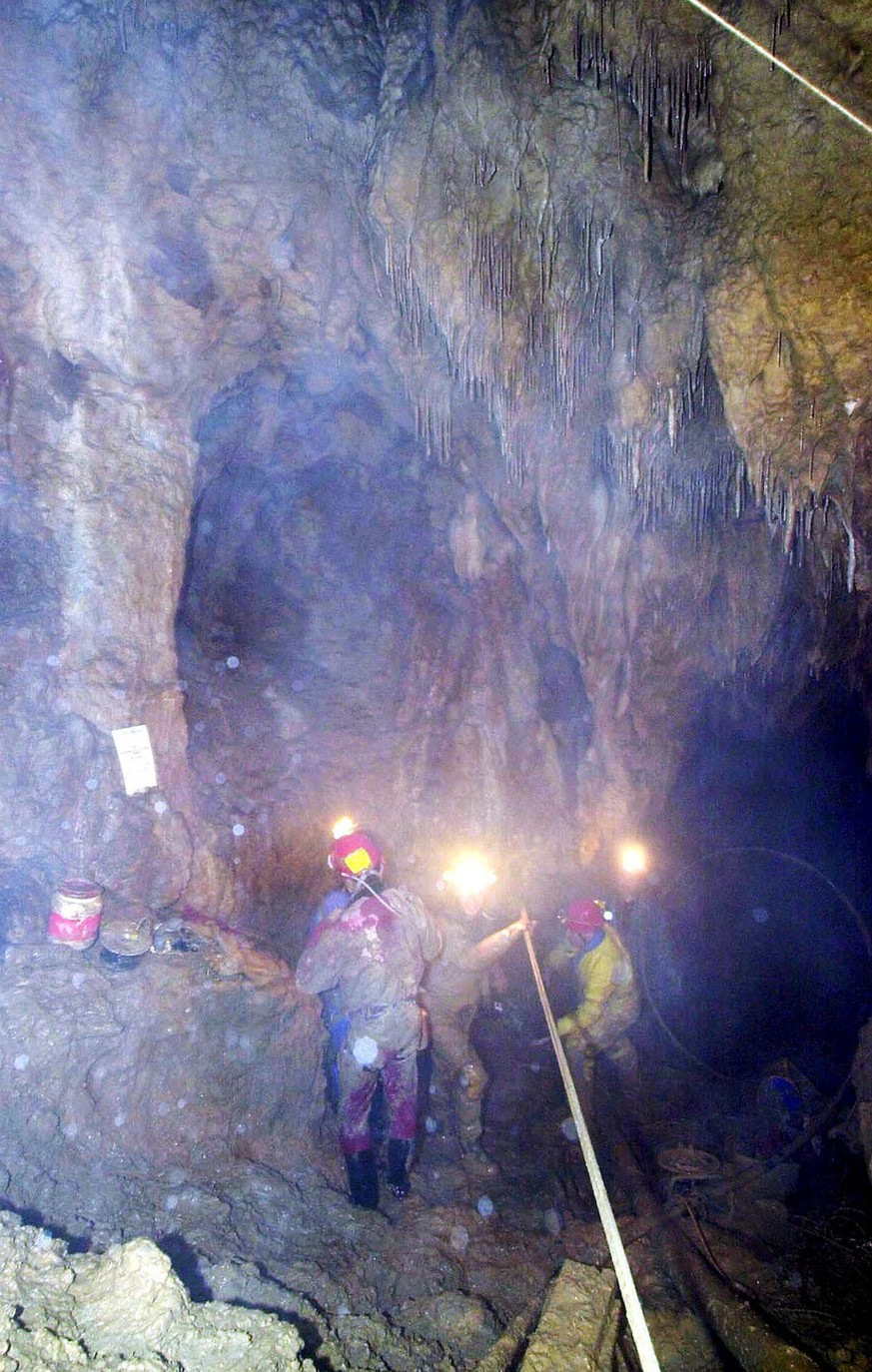 Rescuers work at the entrance of the siphon that separates the rescuers from eight Swiss potholers trapped in the cave of Goumois, Eastern France, Saturday, May 19, 2001 since Wednesday evening. Rescu ...
