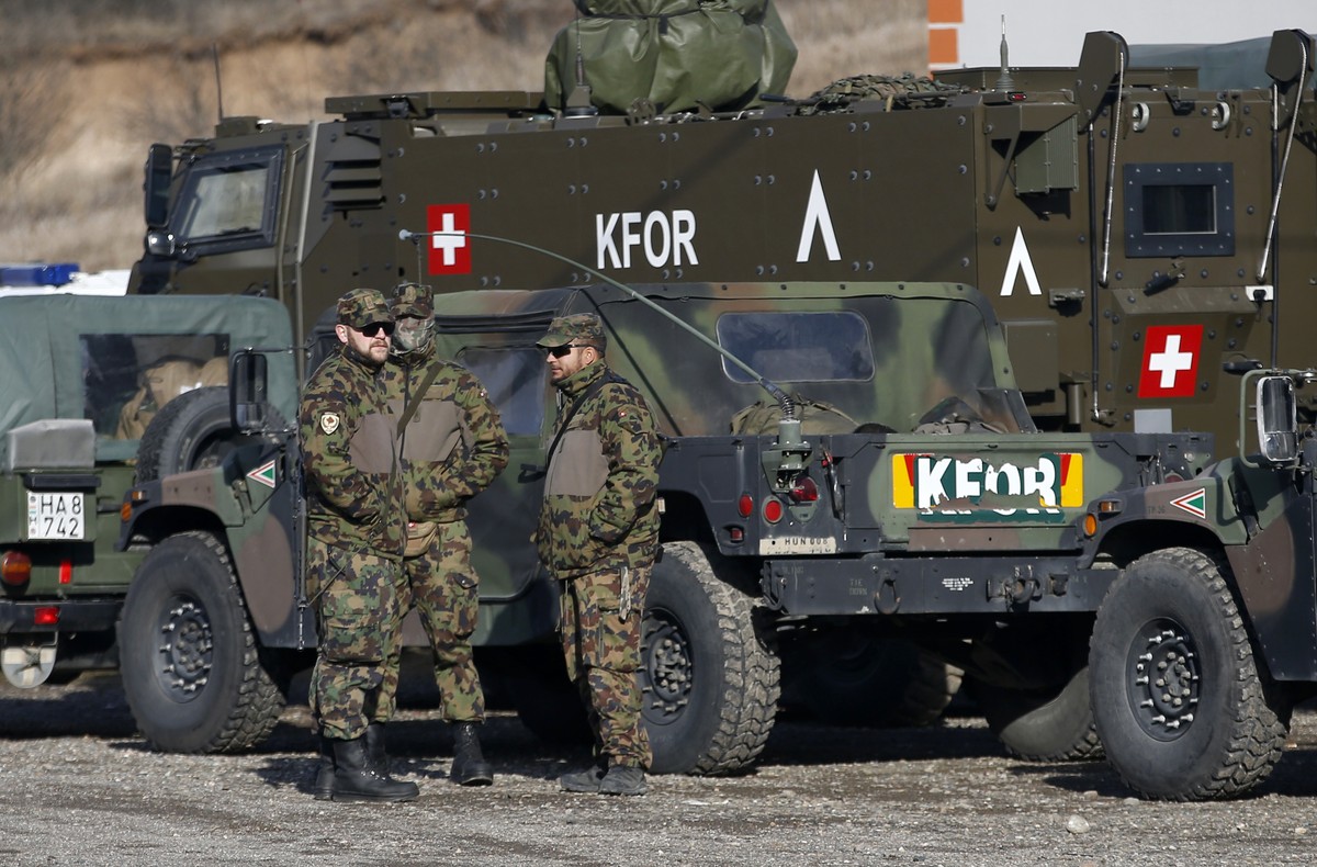 Soldiers of NATO-led peacekeeping force KFOR take a break by the side of the road near the village of Leposavic, northern Kosovo, Thursday, Dec. 13, 2018. In Friday’s vote, Kosovo's 120-seat parl ...