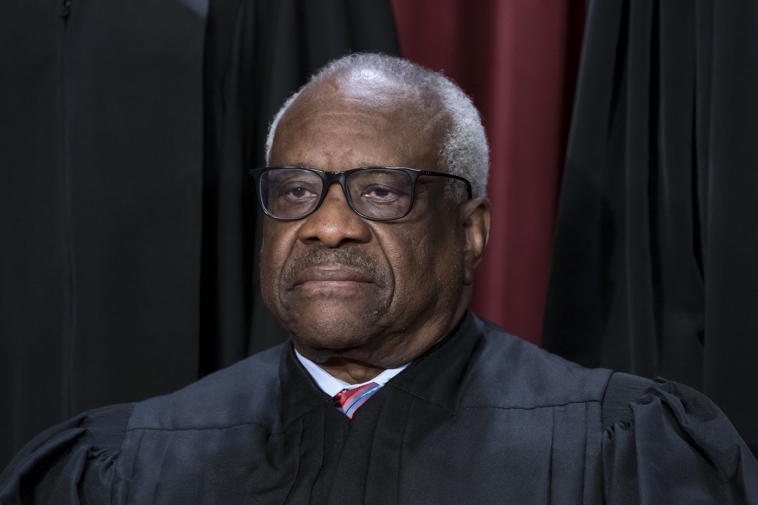 FILE - Associate Justice Clarence Thomas joins other members of the Supreme Court as they pose for a new group portrait, at the Supreme Court building in Washington, Oct. 7, 2022. Thomas said Friday,  ...