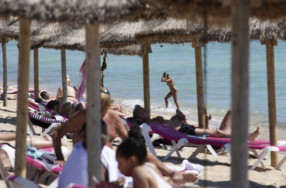 FILE - In this June 7, 2021, file photo, tourists sunbathe on the beach at the Spanish Balearic Island of Mallorca, Spain. Countries across Europe are scrambling to accelerate coronavirus vaccinations ...