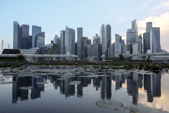 epa06788677 The skyline of Singapore&#039;s financial district is reflected in a lotus pond at the ArtScience Museum in Singapore, 06 June 2018. The White House has confirmed that US President Donald  ...