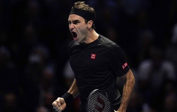 epa07997102 Roger Federer of Switzerland reacts after winning his round robing match against Novak Djokovic of Serbia at the ATP World Tour Finals tennis tournament in London, Britain, 14 November 201 ...