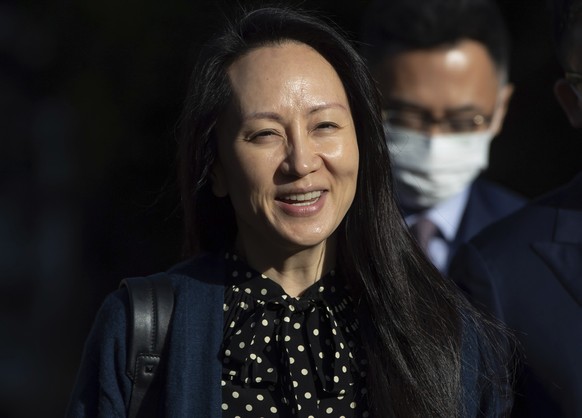 FILE - In this Sept. 24, 2021, file photo, Meng Wanzhou, chief financial officer of Huawei, smiles as she leaves her home in Vancouver. A pair of American siblings, Cynthia and Victor Liu, have return ...