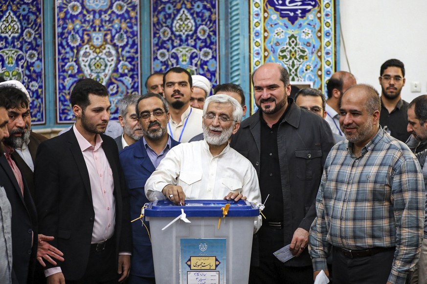 In this photo provided by Iranian Students&#039; News Agency, ISNA, hard-line former Iranian senior nuclear negotiator and candidate for the presidential election Saeed Jalili casts his ballot in a po ...