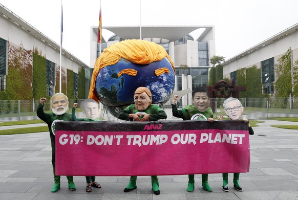 epa06055529 A group of protestors wearing masks of world leaders demonstrate outside the German Chancellery ahead of the arrival of the European leaders in Berlin, Germany, 29 July 2017. The group are ...