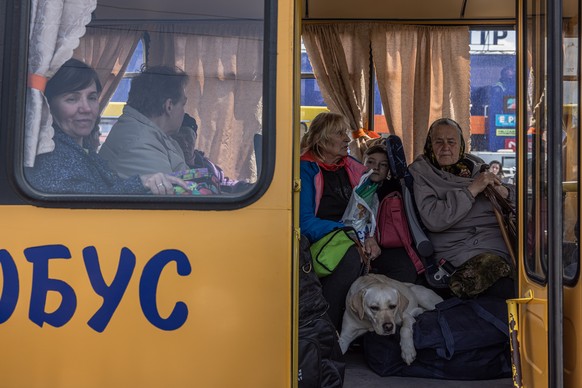 epa09922320 Internally displaced people sit in a bus after arriving from the frontline town of Orikhiv, at the evacuation point in Zaporizhzhia, Ukraine, 02 May 2022. Thousands of people who still rem ...
