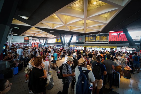 epa07733029 Passengers waiting at Central train station in Naples, southern Italy, 22 July 2019. An arson fire in a rail transformer room on the outskirts of Florence has caused train chaos in Italy o ...