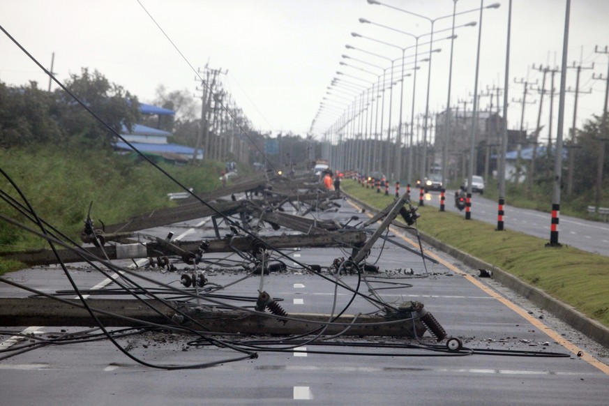 A row of toppled powerlines from Tropical Storm Pabuk block a main highway, Friday, Jan. 4, 2019, in Pak Phanang, in the southern province of Nakhon Si Thammarat, southern Thailand. Rain, winds and su ...