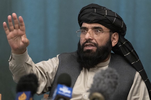 FILE - In this March 19, 2021 file photo, Suhail Shaheen, Afghan Taliban spokesman and a member of the negotiation team gestures while speaking during a joint news conference in Moscow, Russia. In an  ...