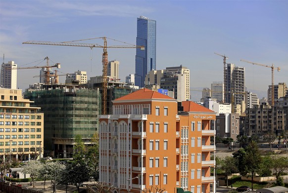 In this Monday, April 2, 2018 photo, construction cranes line the horizon, in Beirut, Lebanon. Some 50 countries and international organizations are expected at the CEDRE (Cedar) conference that begin ...