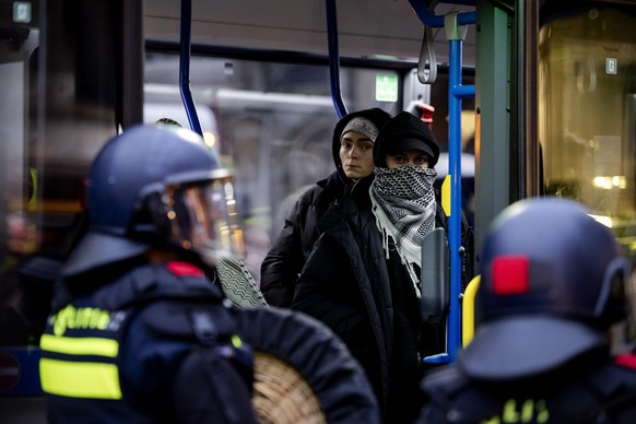 epa11713493 Demonstrators are carried off by police in a bus after a pro-Palestinian protest in Dam Square in Amsterdam, the Netherlands, 10 November 2024. The protest took place while an emergency or ...
