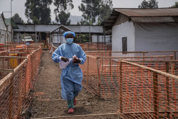 A health worker walks past a mpox treatment centre in Munigi, eastern Congo, Friday, Aug. 16, 2024. (AP Photo/Moses Sawasawa)