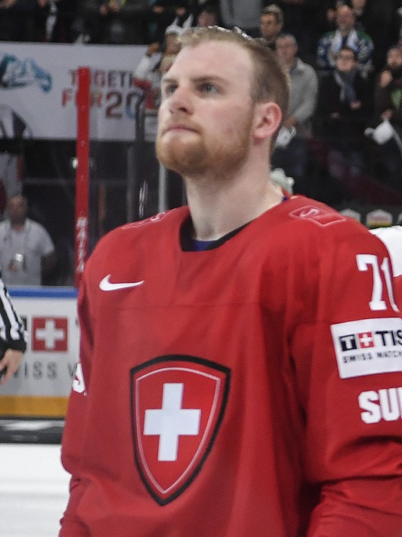 Switzerlandâs Tanner Richard, Denis Malgin, Cody Almond and goaltender Jonas Hiller, from left, listen to the national anthem after the Ice Hockey World Championship group B preliminary round match  ...