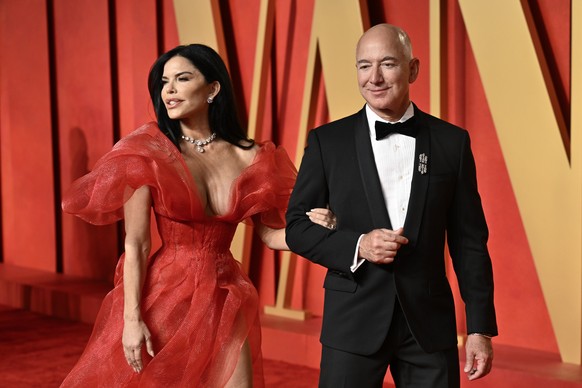 Lauren Sanchez, left, and Jeff Bezos arrive at the Vanity Fair Oscar Party on Sunday, March 10, 2024, at the Wallis Annenberg Center for the Performing Arts in Beverly Hills, Calif. (Photo by Evan Ago ...