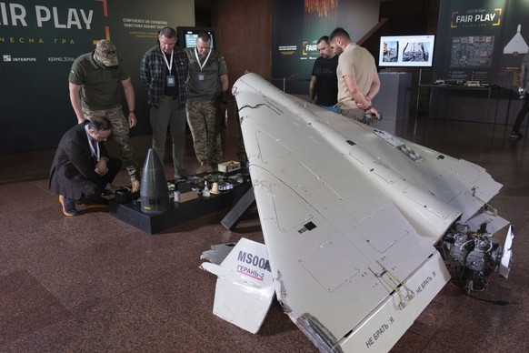Visitors look at a damaged Iranian-made drone, Shahed, during the International Conference on Expanding Sanctions Against Russia in Kyiv, Ukraine, Friday, June 27, 2025. (AP Photo/Efrem Lukatsky)
Russ ...
