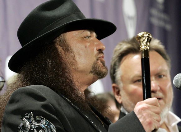 FILE - Gary Rossington from the band Lynyrd Skynyrd answers questions as Ed King looks on, backstage after being inducted at the annual Rock and Roll Hall of Fame dinner in New York, Monday, March 13, ...