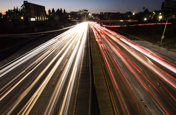 epa07849933 A long exposure picture shows the lights of vehicles traveling along Freeway 101 in Los Angeles, California, USA, 17 September 2019. President Trump is tomorrow expected to revoke a rule d ...