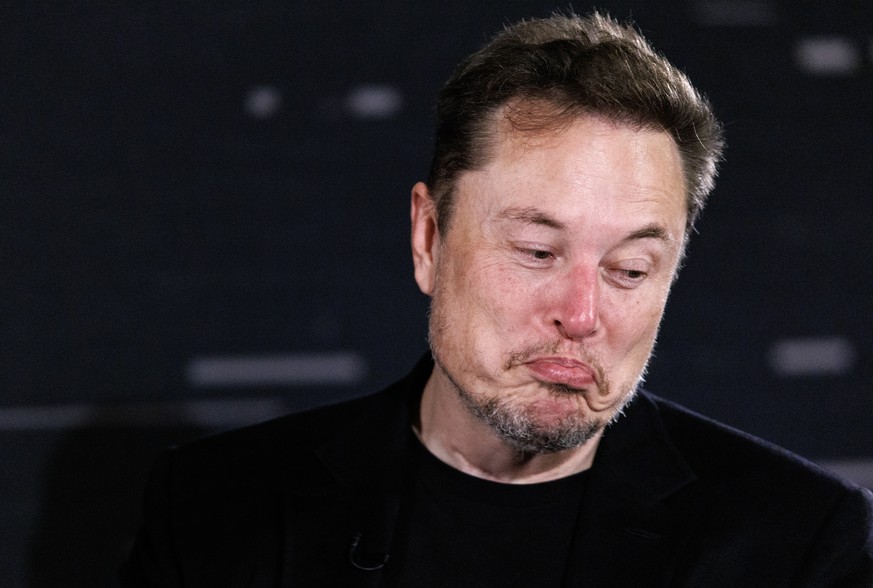 epa10998583 US tech entrepreneur Elon Musk, owner of Tesla, SpaceX and X, reacts as he attends a conversation event with British Prime Minister Rishi Sunak (unseen) in central London, Britain, 02 Nove ...