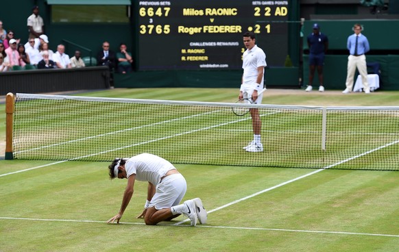 epa05415837 Roger Federer of Switzerland takes a fall as he plays Milos Raonic of Canada in their semi final match during the Wimbledon Championships at the All England Lawn Tennis Club, in London, Br ...