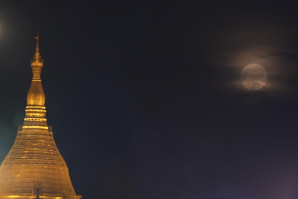 Myanmar Landmark Shwedagon is illuminated while a supermoon rises during the full moon day of Thadingyut, the end of Buddhist Lent, Thursday, Oct. 17, 2024, in Yangon, Myanmar. (AP Photo/Thein Zaw)