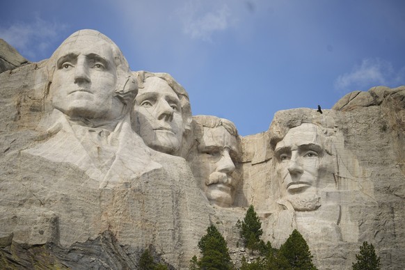 Visitors take in the massive sculpture carved into Mount Rushmore at the Mount Rushmore National Memorial Thursday, Sept. 21, 2023, in, Keystone, S.D. (AP Photo/David Zalubowski)
