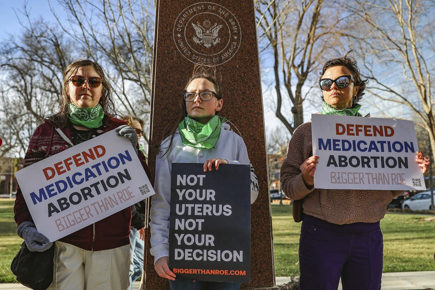 FILE - Three members of the Women&#039;s March group protest in support of access to abortion medication outside the Federal Courthouse on Wednesday, March 15, 2023 in Amarillo, Texas. Matthew Kacsmar ...