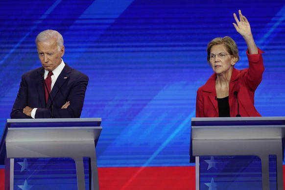 Former Vice President Joe Biden, left, and Sen. Elizabeth Warren, D-Mass., right, Thursday, Sept. 12, 2019, listen during a Democratic presidential primary debate hosted by ABC at Texas Southern Unive ...