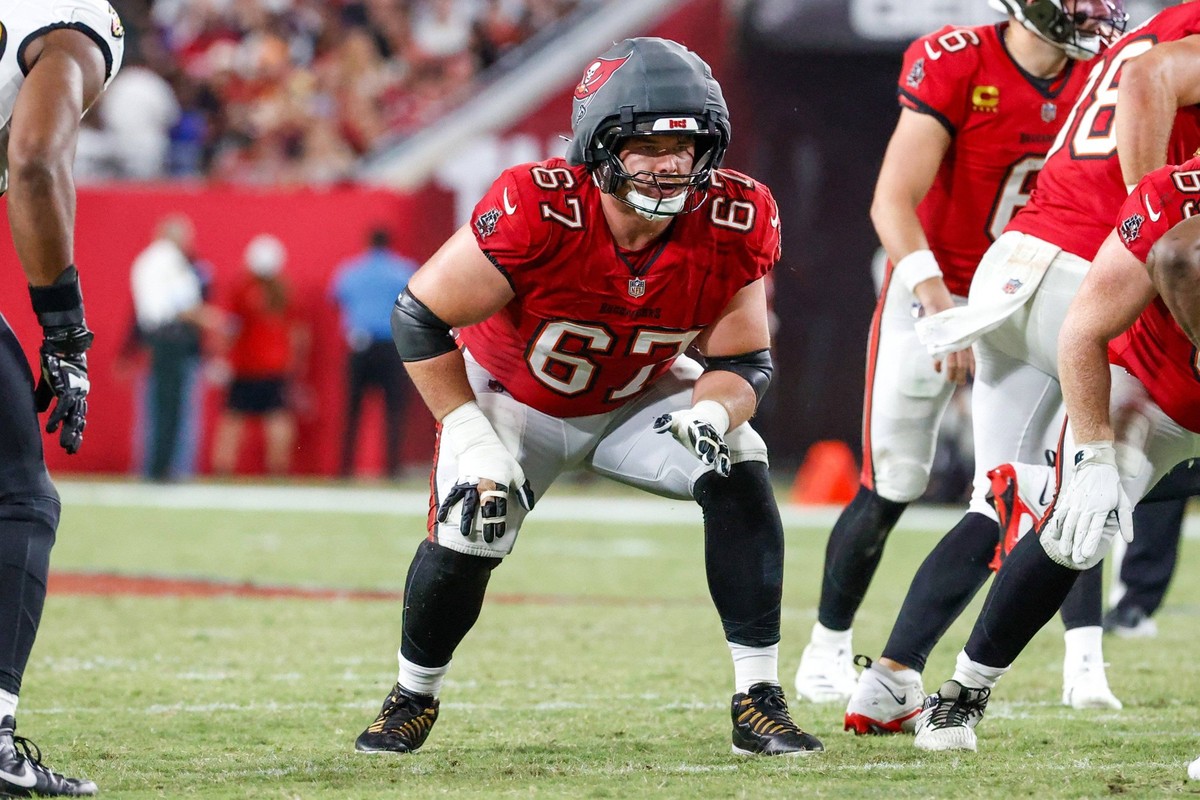 October 21, 2024, Tampa, Florida, USA: Tampa Bay Buccaneers offensive tackle Luke Goedeke 67 wears a guardian cap, while he waits for the ball to be snapped and to block a Ravens defender during the f ...