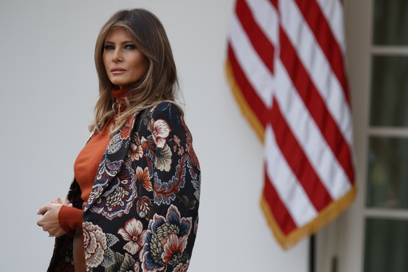 FILE - In this Nov. 21, 2017, file photo, first lady Melania Trump listens as President Donald Trump speaks during the National Thanksgiving Turkey Pardoning Ceremony in the Rose Garden of the White H ...