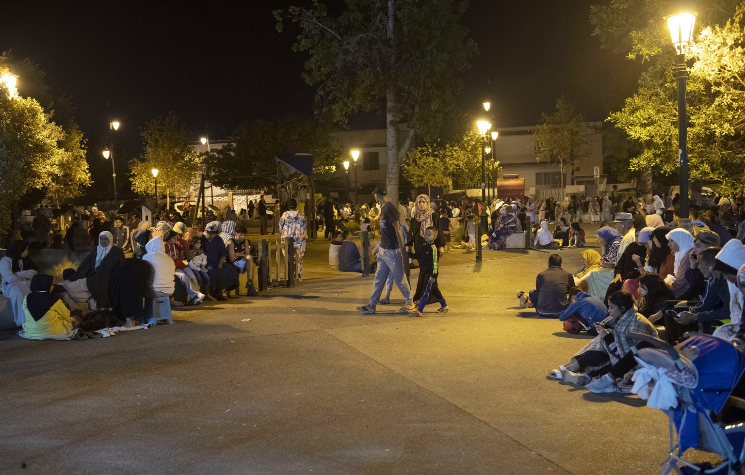 epa10849890 People seek safety outside after an earthquake in Rabat, Morocco, 08 September 2023. A 6.8-magnitude earthquake struck Morocco late 08 September, damaging buildings in major cities and sen ...