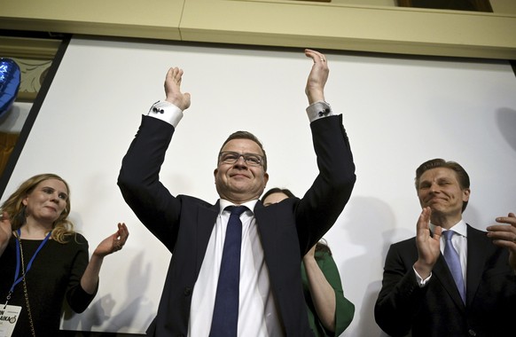 The National Coalition party Chairman Petteri Orpo, center, celebrates at the party&#039;s parliament election party at the Ostrobotnia club in Helsinki, Finland on Sunday, April 2, 2023. Finland?s ce ...